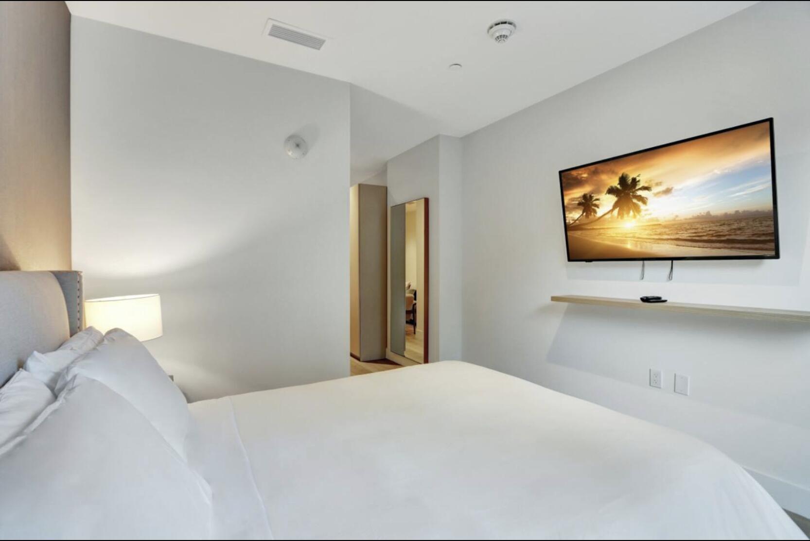 229 Southwest 9th Street, Unit 201 Miami, FL 33130 - Photo 10 of 21 a bedroom with a bed and a flat screen tv