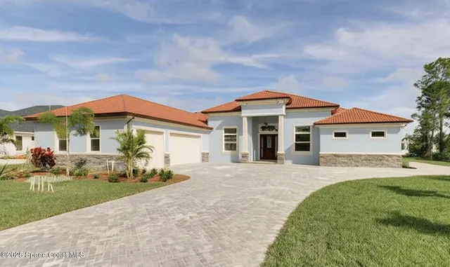 a front view of a house with a garden and yard