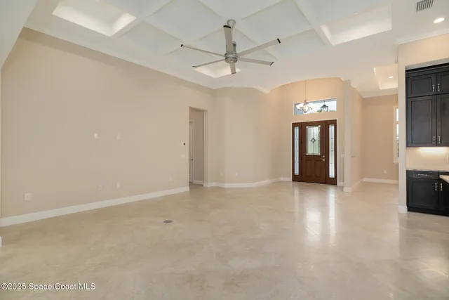 a large kitchen with a large island in the center and stainless steel appliances