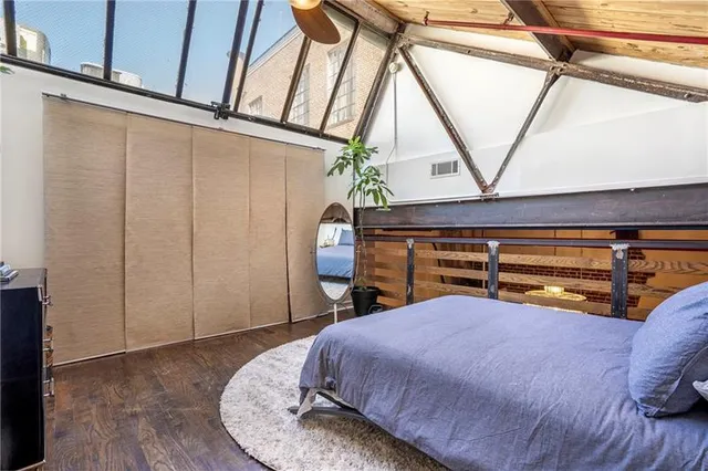 a bed sitting in a bedroom next to a window