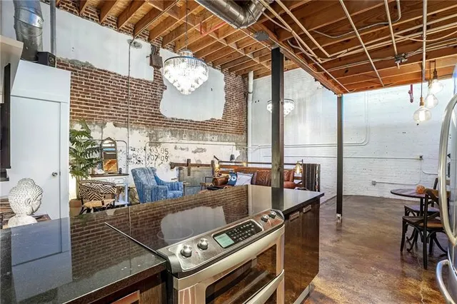 a view of a dining room with furniture a chandelier and wooden floor