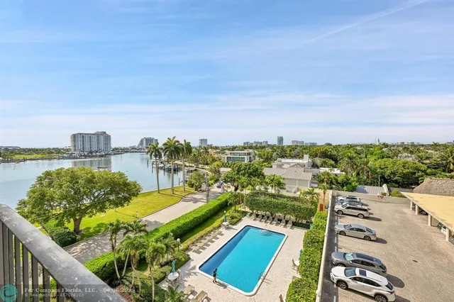a view of a lake with couches with wooden floor and city view