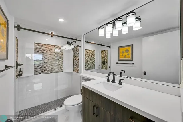 a bedroom with a bed a large window and walk in closet