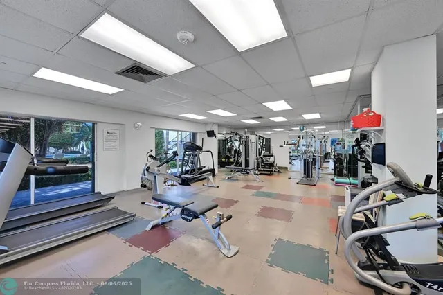a view of a swimming pool with a lawn chairs and plants