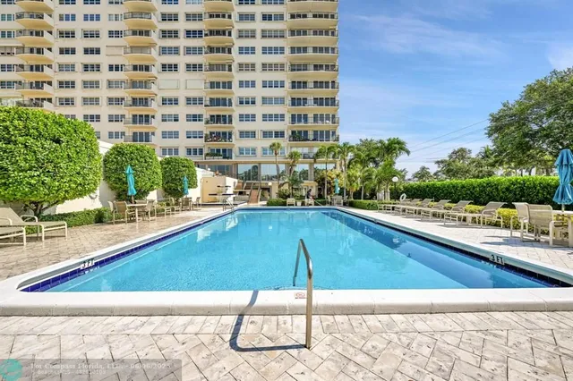 a view of a patio with a table and chairs and potted plants