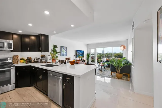 a kitchen with sink a refrigerator and cabinets