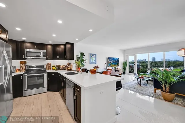 a kitchen with a sink a counter top stainless steel appliances and cabinets