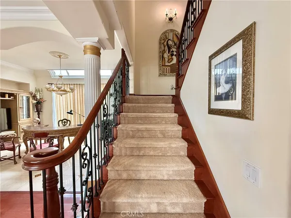 a view of staircase with lots of frames and frames on wall