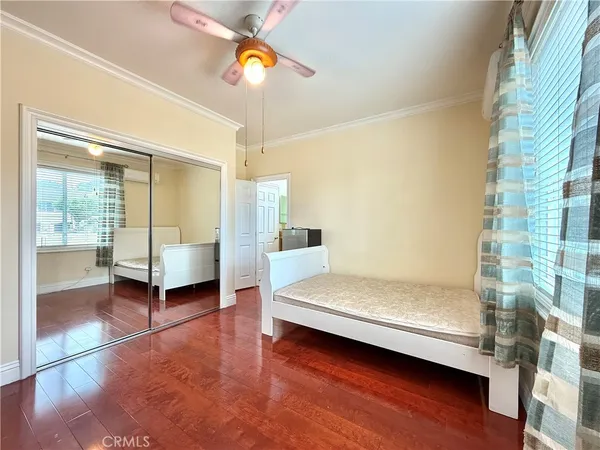 a spacious bedroom with a bed and a chandelier