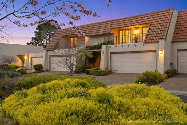 a front view of a house with a garden
