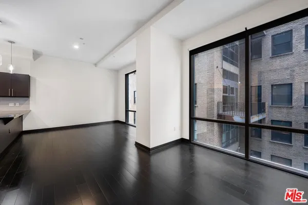 a view of a room with wooden floor and window