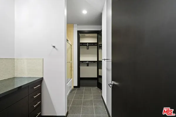 a bathroom with a shower and a sink