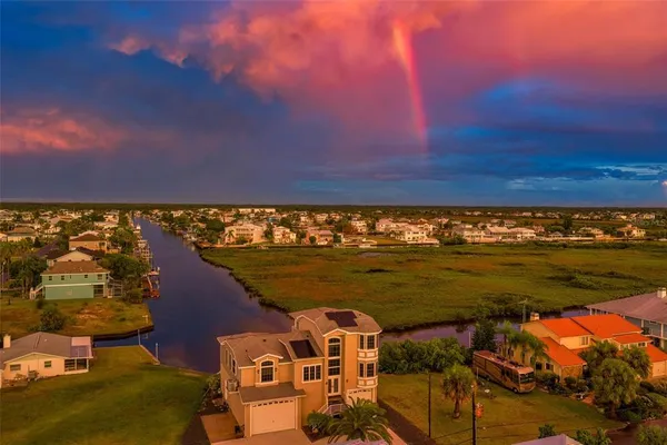 an aerial view of a houses with ocean view