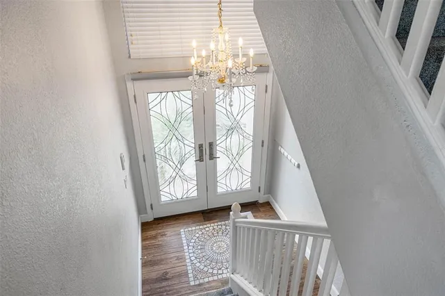 a living room with furniture kitchen view and a large window