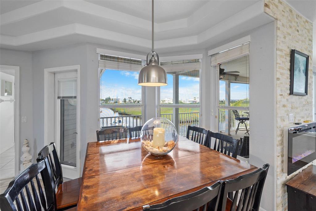 3280 Gulf Winds Circle Hernando Beach, FL 34607 - Photo 18 of 68 a dining room with furniture a chandelier and wooden floor