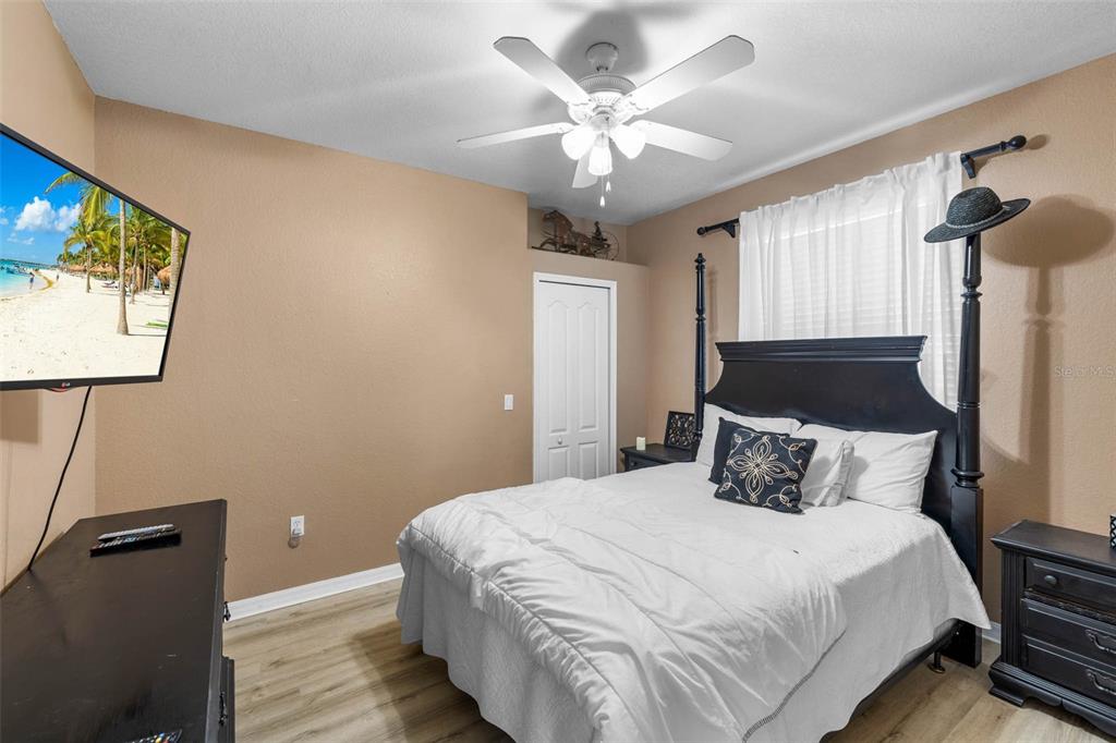 3280 Gulf Winds Circle Hernando Beach, FL 34607 - Photo 26 of 68 a bedroom with a large bed and a chandelier