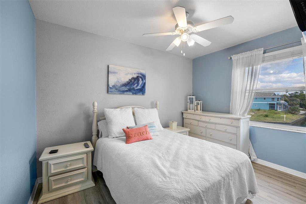 3280 Gulf Winds Circle Hernando Beach, FL 34607 - Photo 29 of 68 a bedroom with a large bed and a chandelier