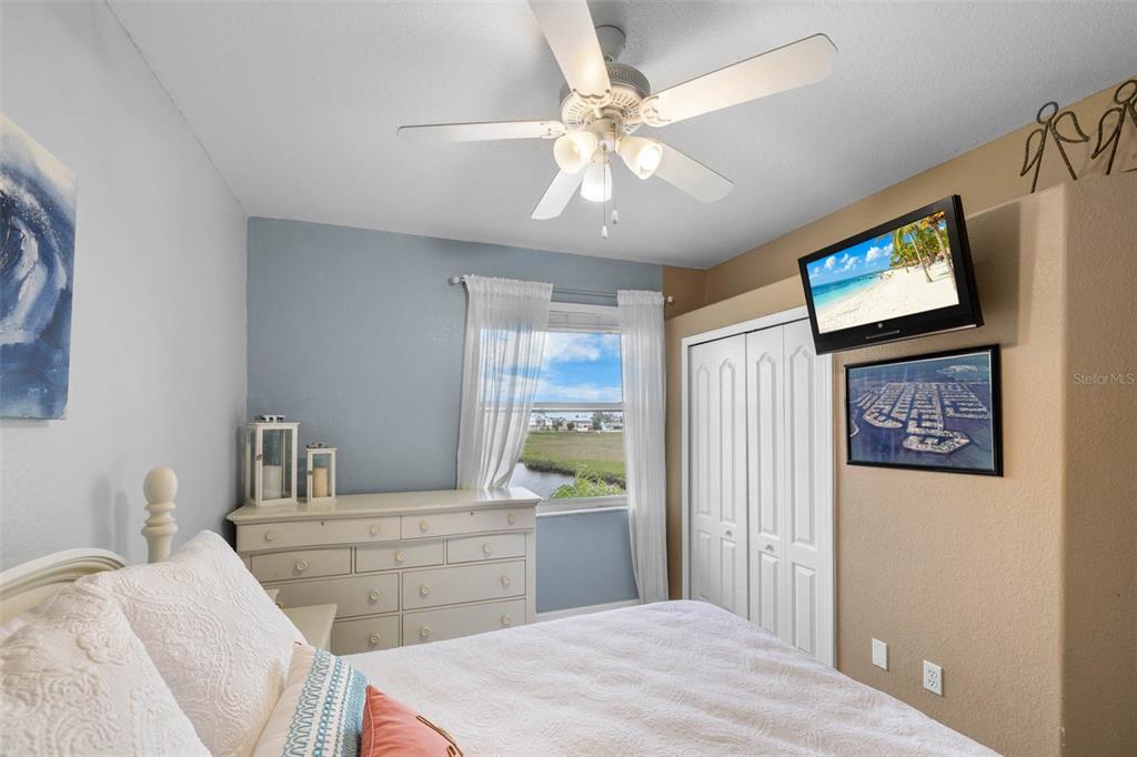 3280 Gulf Winds Circle Hernando Beach, FL 34607 - Photo 30 of 68 a bedroom with a bed and a flat screen tv