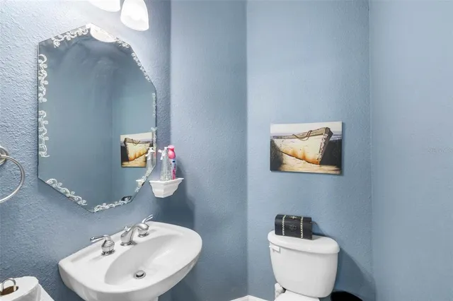 a bathroom with a granite countertop sink double vanity and a mirror