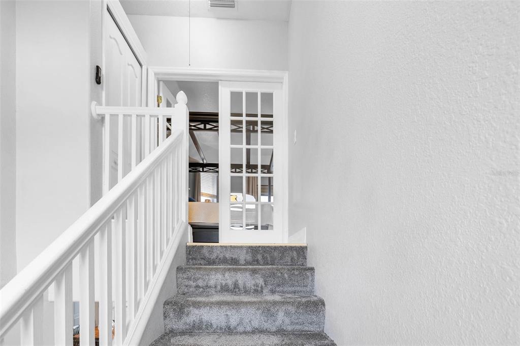3280 Gulf Winds Circle Hernando Beach, FL 34607 - Photo 34 of 68 a view of staircase with lots of frames on wall and stairs