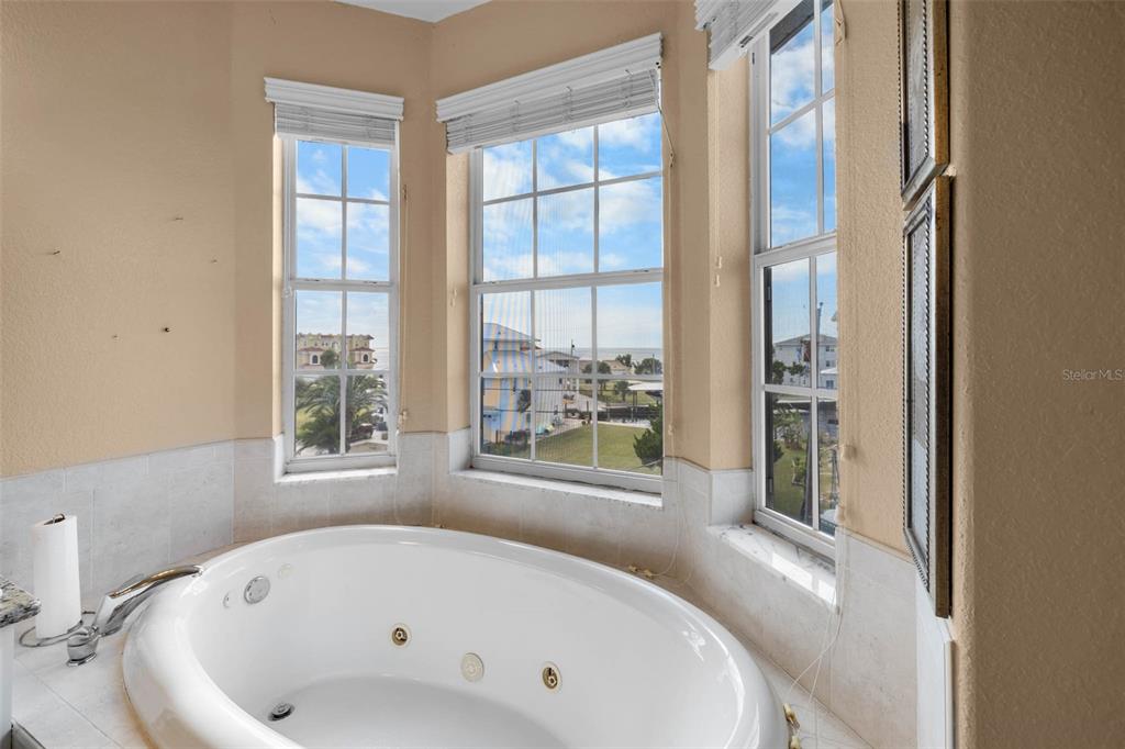 3280 Gulf Winds Circle Hernando Beach, FL 34607 - Photo 40 of 68 a bathroom with a bathtub and windows