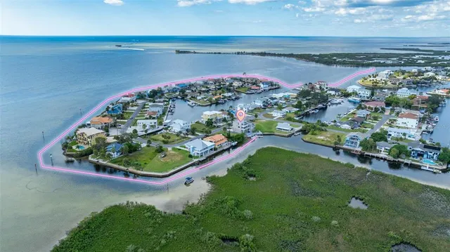 a view of a balcony with wooden floor next to a lake