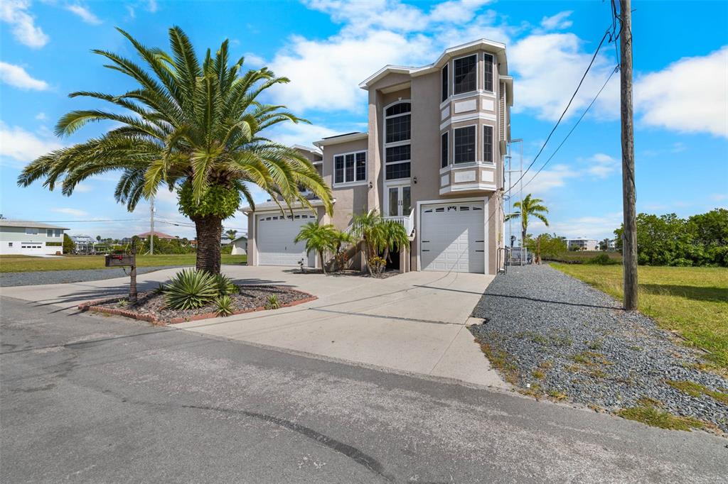3280 Gulf Winds Circle Hernando Beach, FL 34607 - Photo 47 of 68 a front view of a house with a yard and garage