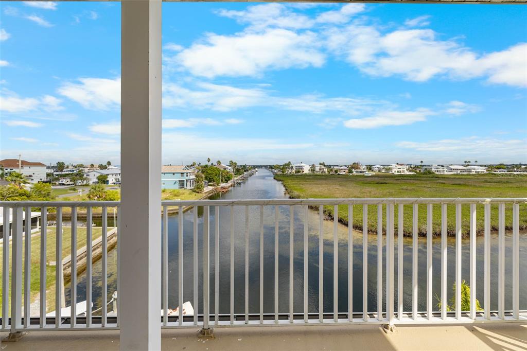 3280 Gulf Winds Circle Hernando Beach, FL 34607 - Photo 6 of 68 a view of a balcony with wooden floor next to a lake