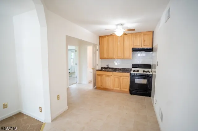 a kitchen with a refrigerator and a stove top oven