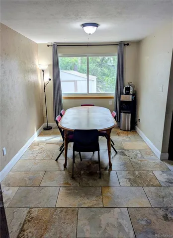a very nice looking dining room with a large window