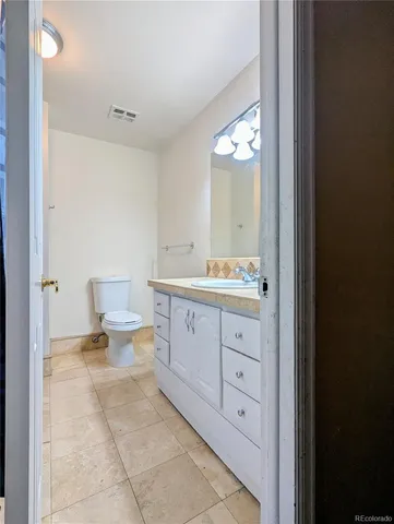 a spacious bathroom with a double vanity sink and a mirror