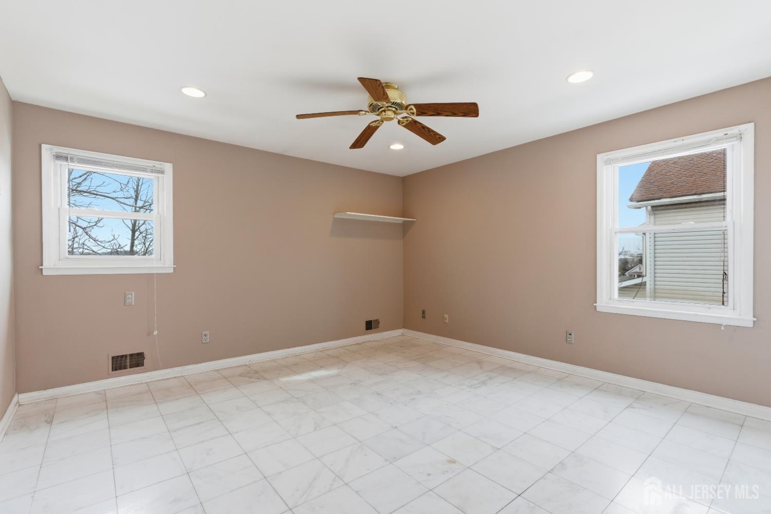 6 Cherry Street Edison, NJ 08817 - Photo 13 of 30 an empty room with windows and fan
