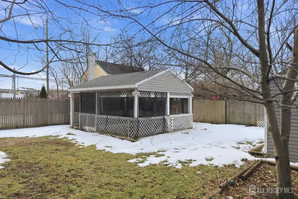 a view of a yard covered with snow in front of house