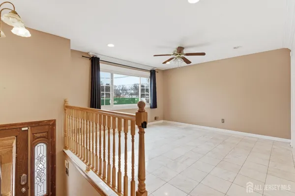 a view of a hallway with a ceiling fan