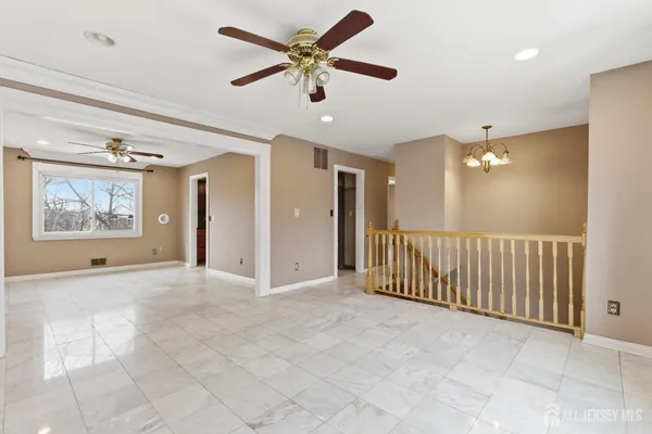 a view of a livingroom with a ceiling fan and window