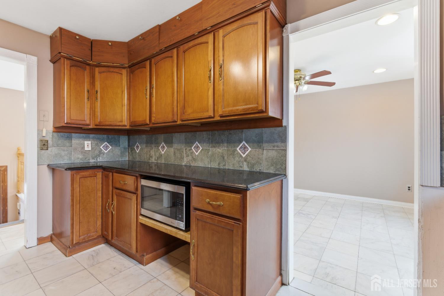 6 Cherry Street Edison, NJ 08817 - Photo 8 of 30 a kitchen with granite countertop a stove and a sink