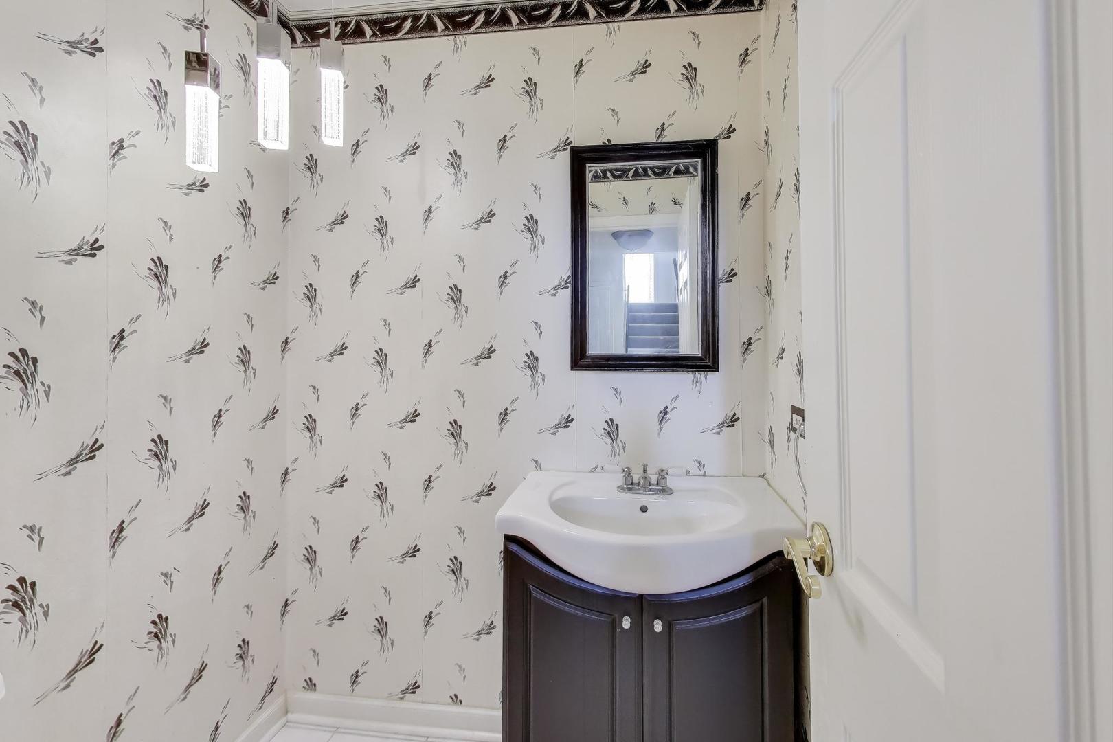 121 South Lancaster Drive Bolingbrook, IL 60440 - Photo 14 of 35 a bathroom with a sink a mirror and shower curtain