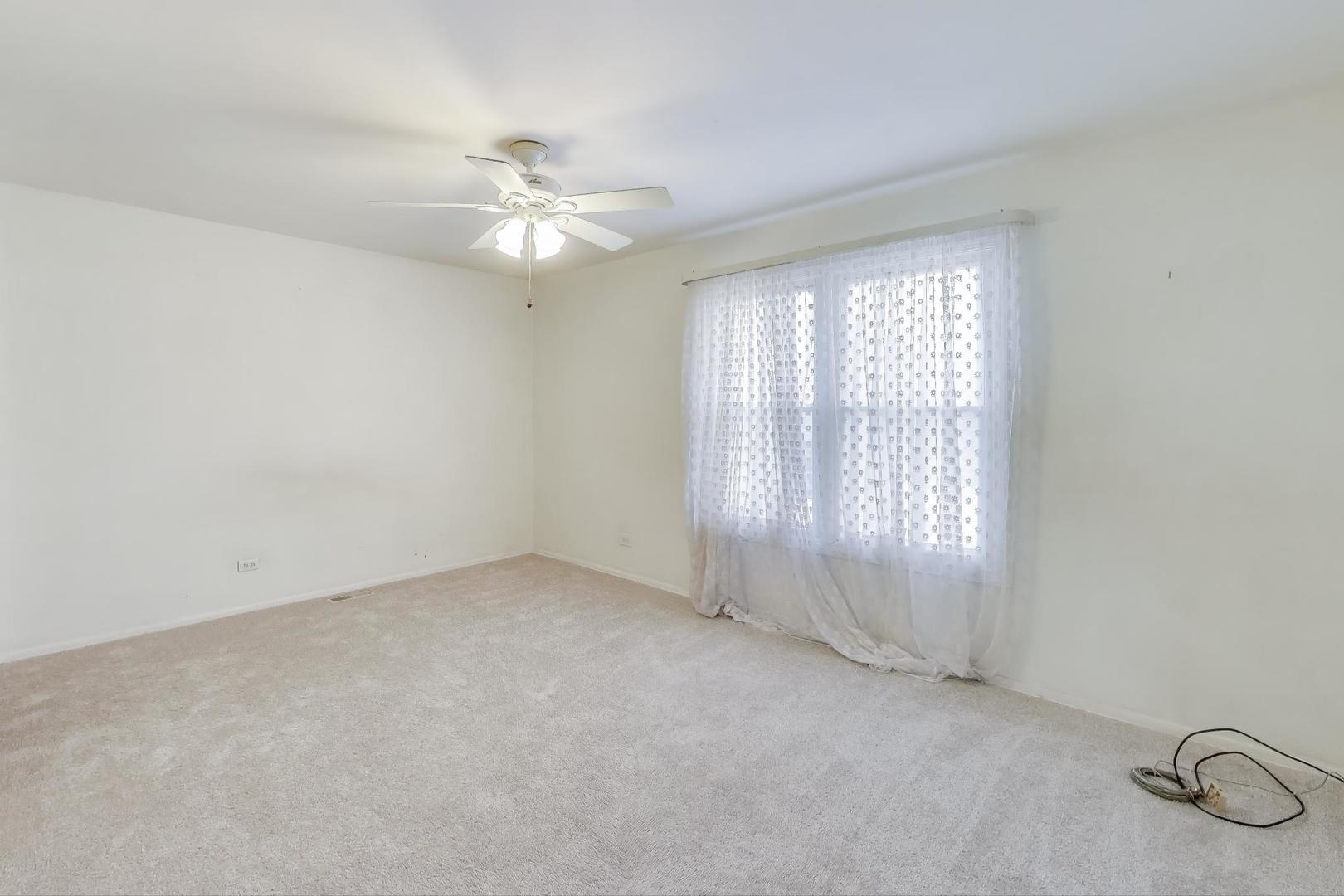 121 South Lancaster Drive Bolingbrook, IL 60440 - Photo 15 of 35 an empty room with windows and fan