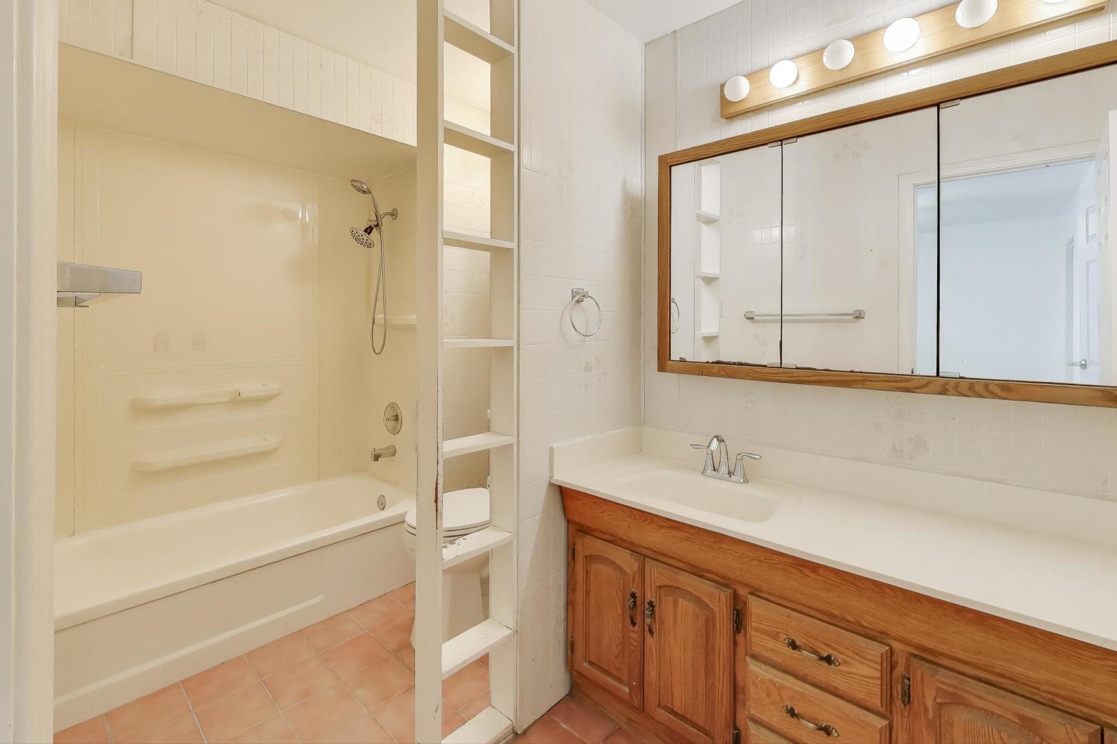 121 South Lancaster Drive Bolingbrook, IL 60440 - Photo 17 of 35 a bathroom with a shower sink and mirror