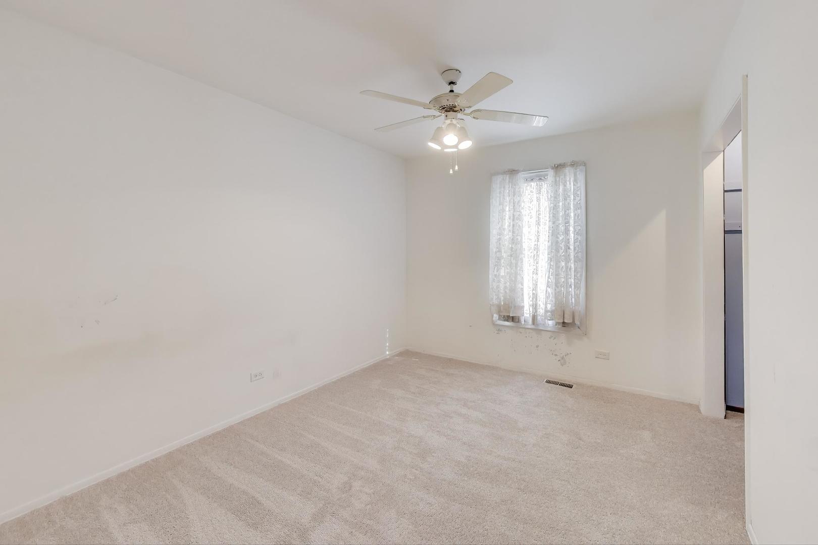 121 South Lancaster Drive Bolingbrook, IL 60440 - Photo 20 of 35 an empty room with windows and fan