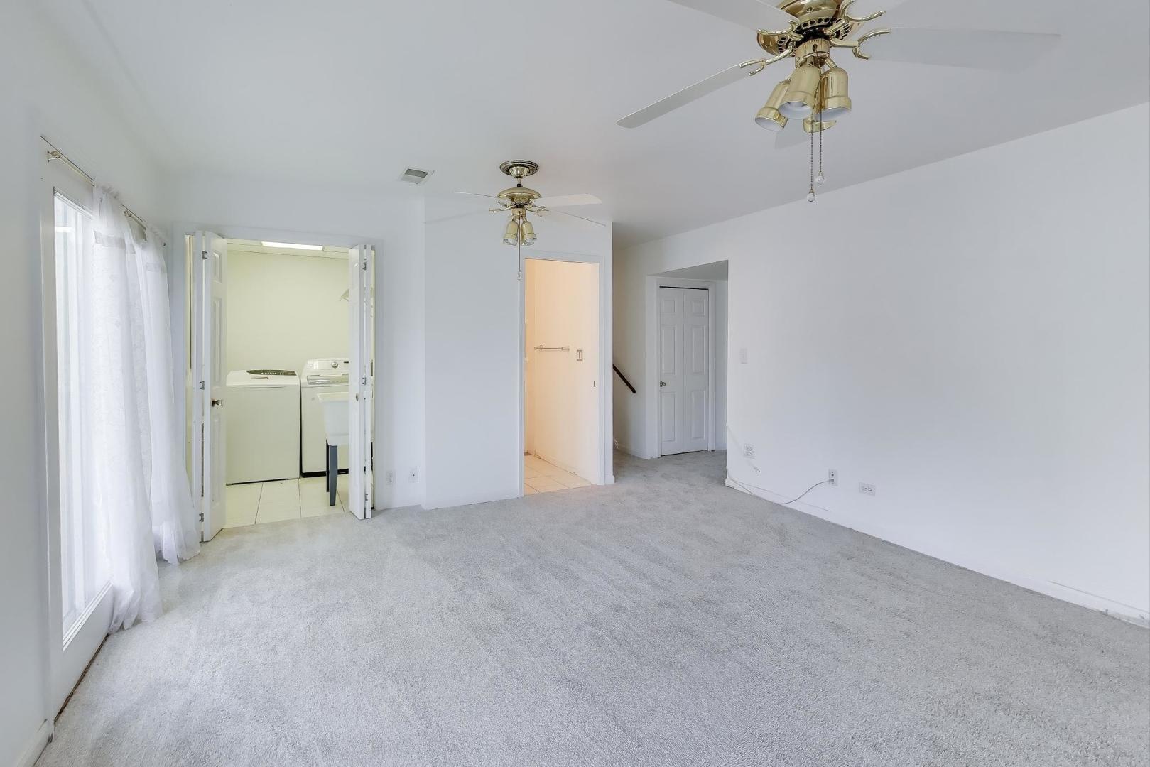 121 South Lancaster Drive Bolingbrook, IL 60440 - Photo 24 of 35 a view of a big room with chandelier fan and windows