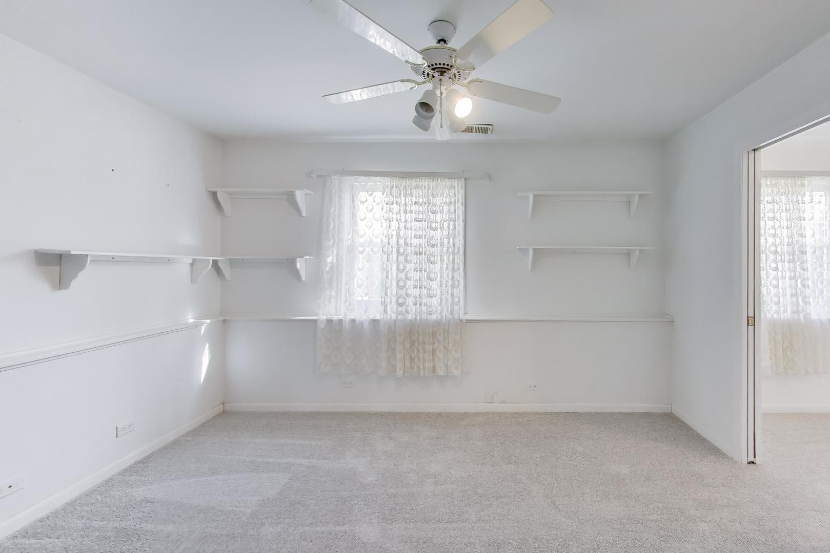 121 South Lancaster Drive Bolingbrook, IL 60440 - Photo 25 of 35 an empty room with windows and fan