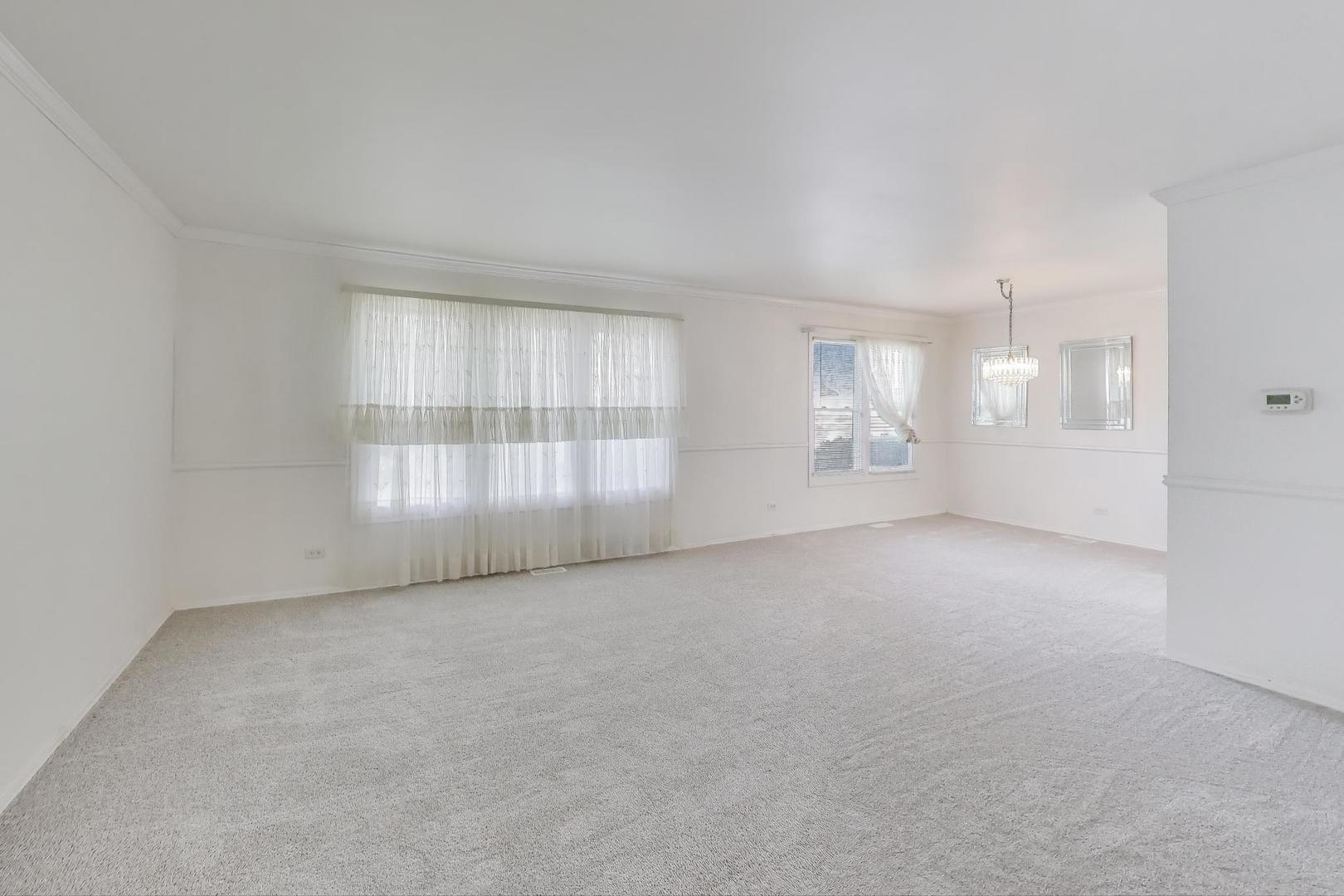 121 South Lancaster Drive Bolingbrook, IL 60440 - Photo 4 of 35 a view of an empty room with a window