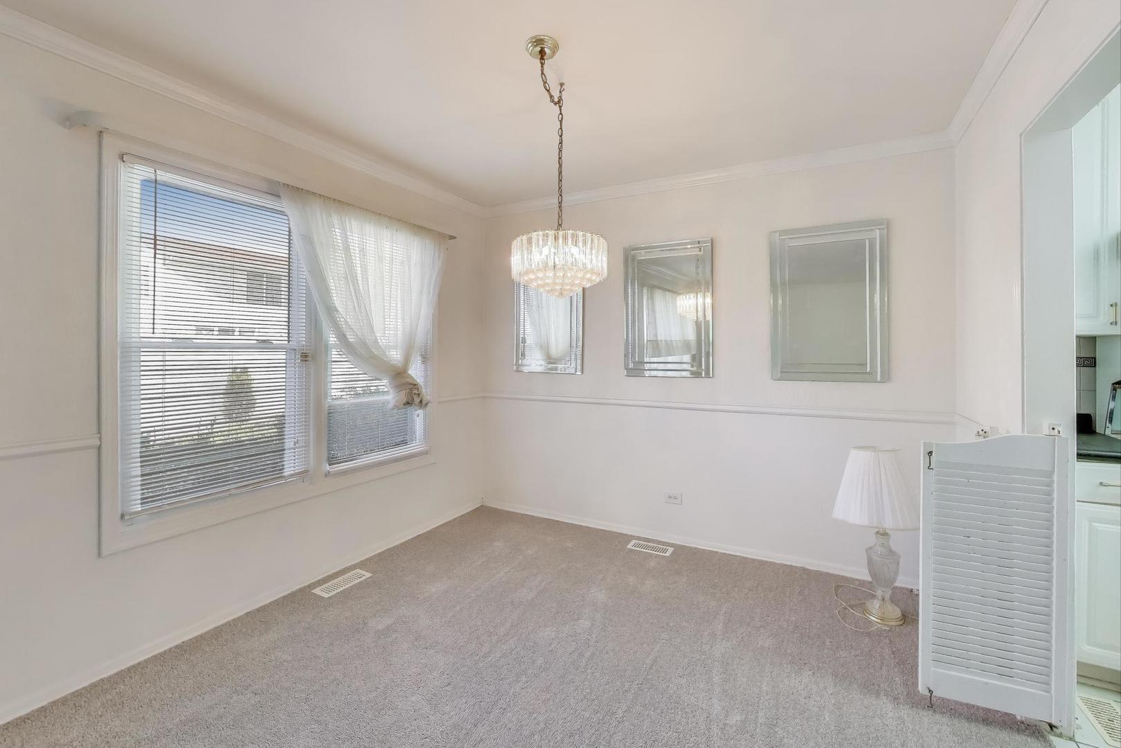 121 South Lancaster Drive Bolingbrook, IL 60440 - Photo 6 of 35 a view of a room with wooden floor and windows