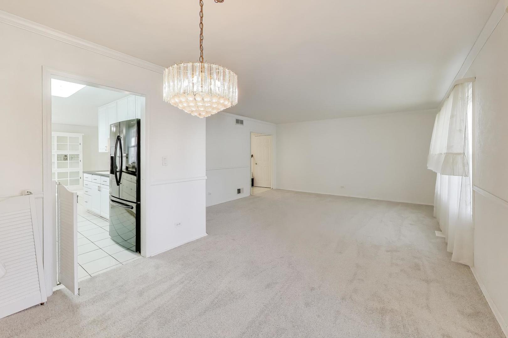 121 South Lancaster Drive Bolingbrook, IL 60440 - Photo 7 of 35 a view of a big room with chandelier and refrigerator