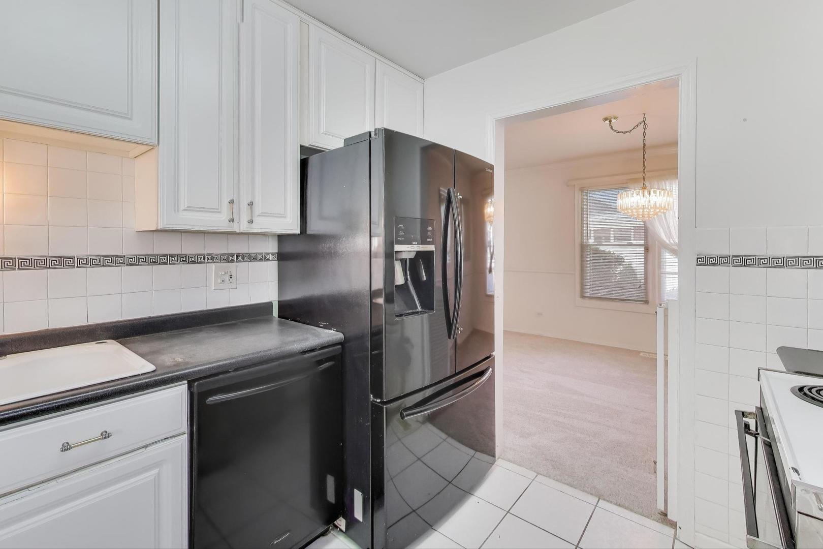 121 South Lancaster Drive Bolingbrook, IL 60440 - Photo 10 of 35 a kitchen with stainless steel appliances granite countertop a refrigerator and a sink