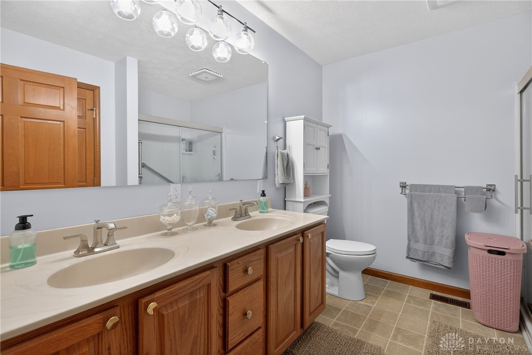 5264 Frazier-Guy Road Sidney, OH 45365 - Photo 24 of 51 This bathroom features dual sinks with ample counter space and a convenient shower.
