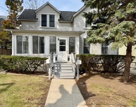front view of a house with a bench