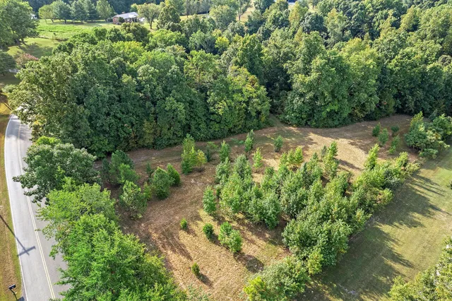 a backyard of a house with a yard and outdoor seating