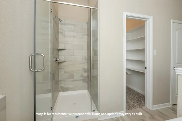 a bathroom with a glass shower door